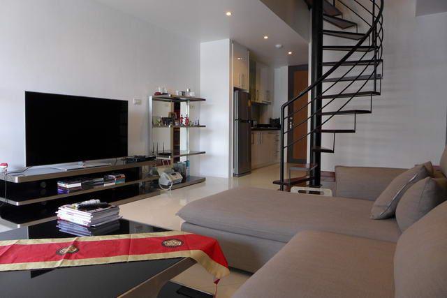 Condominium For Sale Pattaya showing the living area and the kitchen Condominium For Sale Pattaya showing the living area and the kitchen