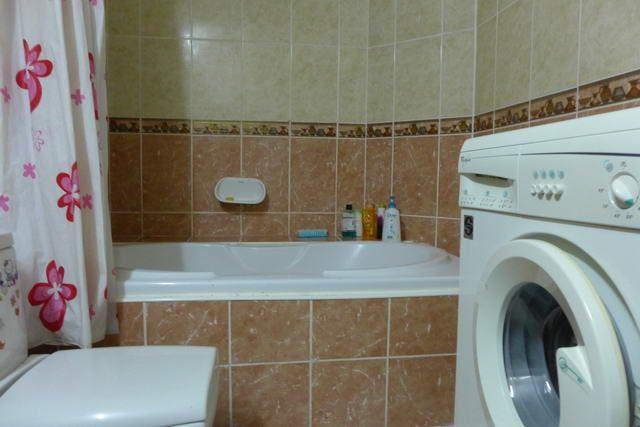 Condominium for sale in Naklua showing the bathroom and washing machine  