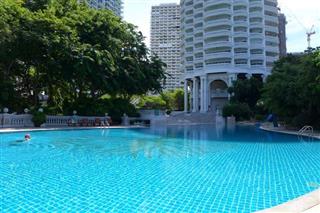 Condominium for sale in Naklua showing the communal pool and building 
