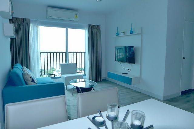 Condominium For Sale Pattaya showing the living area and balcony Condominium For Sale Pattaya showing the living area and balcony