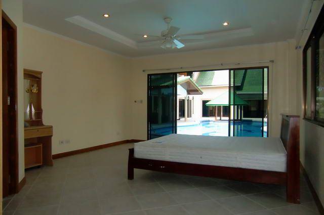 House for sale in Pattaya showing a poolside bedroom House for sale in Pattaya showing a poolside bedroom
