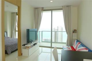 Condominium for sale Wong Amat Pattaya showing the living area and balcony 