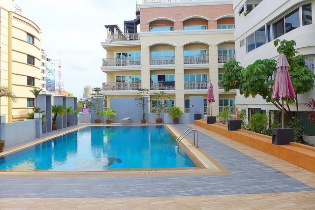 Condominium for sale Pattaya Beach showing the communal pool and condo building