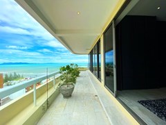 Condominium for sale Na Jomtien showing the master bedroom with balcony  