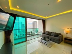 Condominium for sale Wong Amat Pattaya showing the living area and balcony 