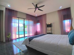 House for sale Huay Yai Pattaya showing the master bedroom with pool view 