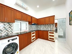 House for sale Pattaya showing the kitchen and guest bathroom 