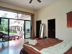 House for sale Pattaya showing the master bedroom suite poolside