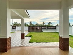 House for sale at Nongplalai Pattaya showing the covered terrace and garden 