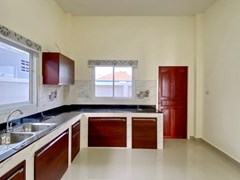 House for sale at Nongplalai Pattaya showing the kitchen and outside utility area 
