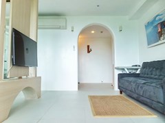 Condominium for sale Bangsaray Pattaya showing the living area and entrance 