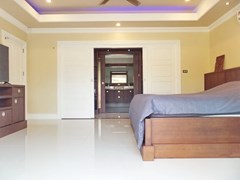 House for sale Nongpalai Pattaya showing the master bedroom with walk-in wardrobes 