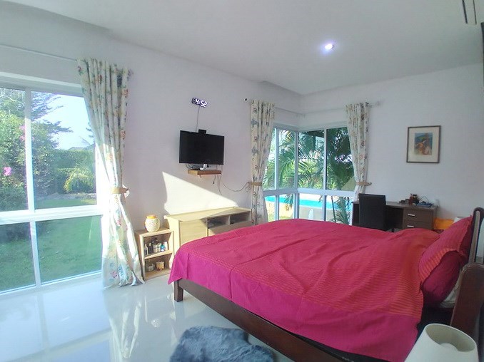 House for sale Huay Yai Pattaya showing the master bedroom with pool view 