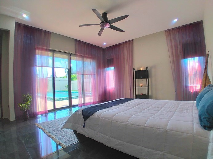 House for sale Huay Yai Pattaya showing the master bedroom with pool view House for sale Huay Yai Pattaya showing the master bedroom with pool view