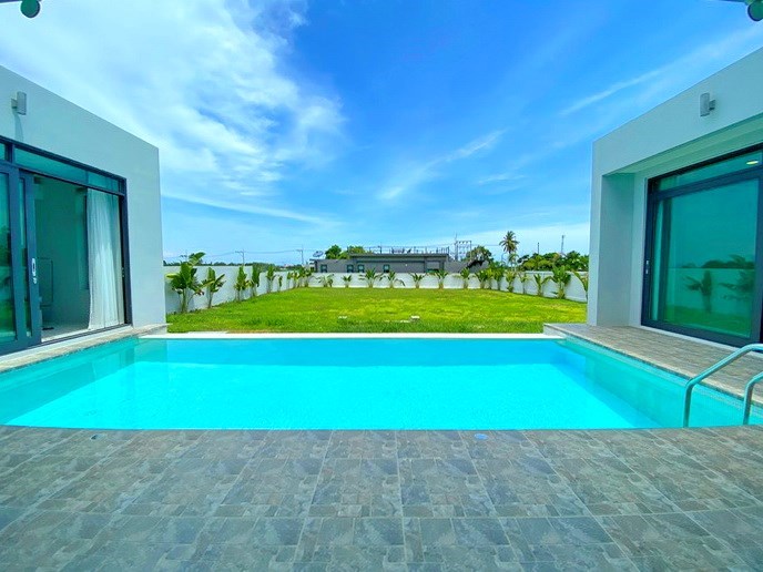 House for sale Mabprachan Pattaya showing the pool and garden extra land plot not included