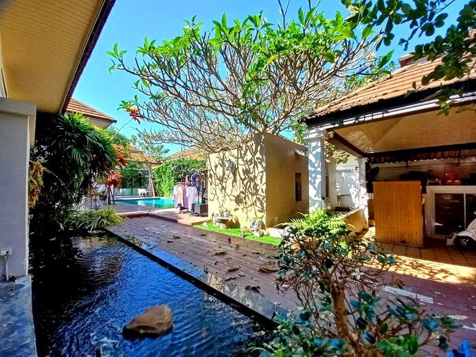 House for sale Pattaya showing the fishpond and garage 