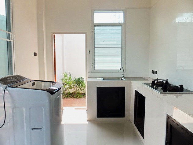 House for sale WongAmat Pattaya showing the kitchen and outside utilities area 