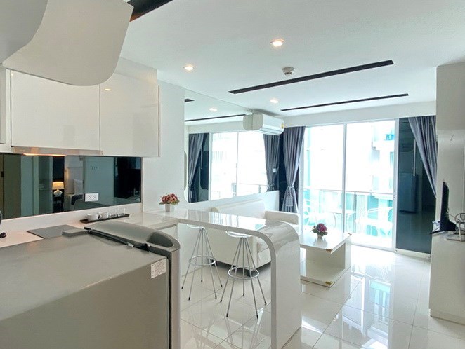 Condominium for sale Pattaya showing the kitchen, living area and balcony 